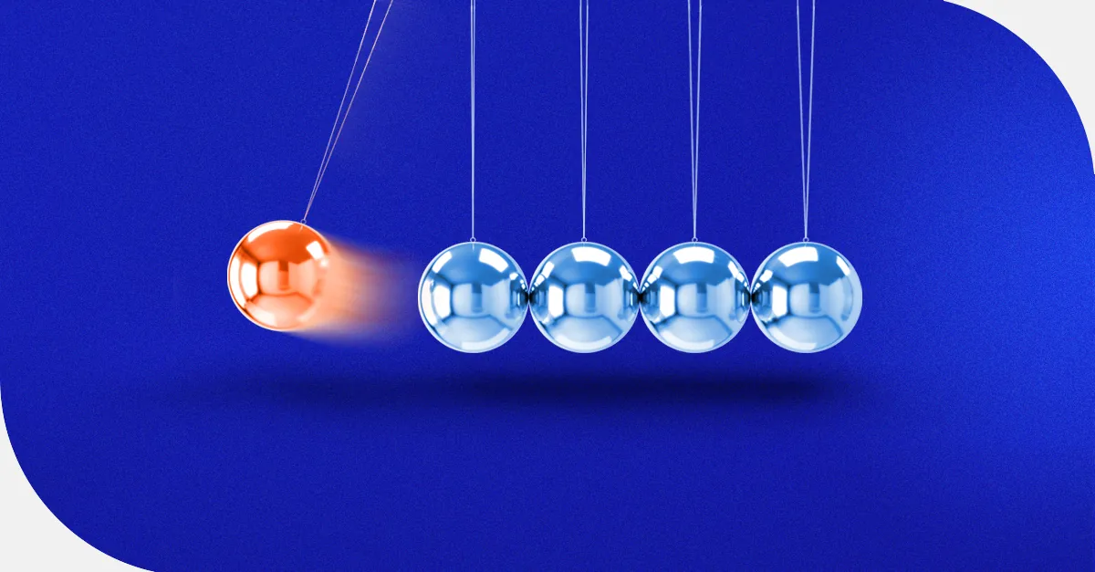 Orange ball swinging to hit four blue metallic balls in a Newton's cradle on a vibrant blue background